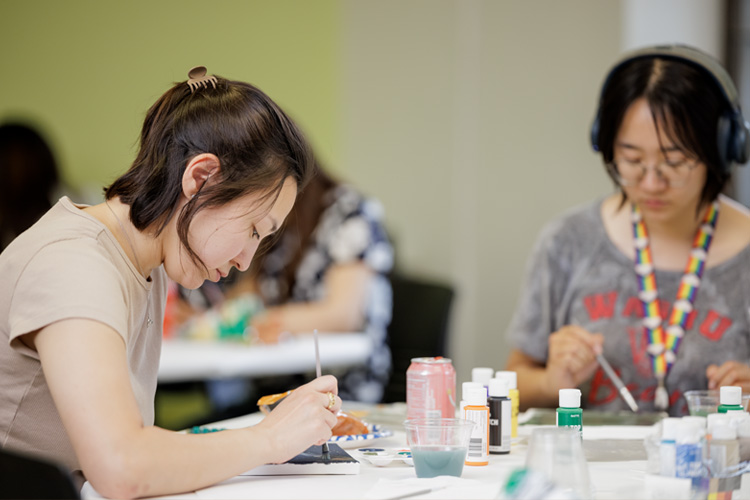 students painting at event