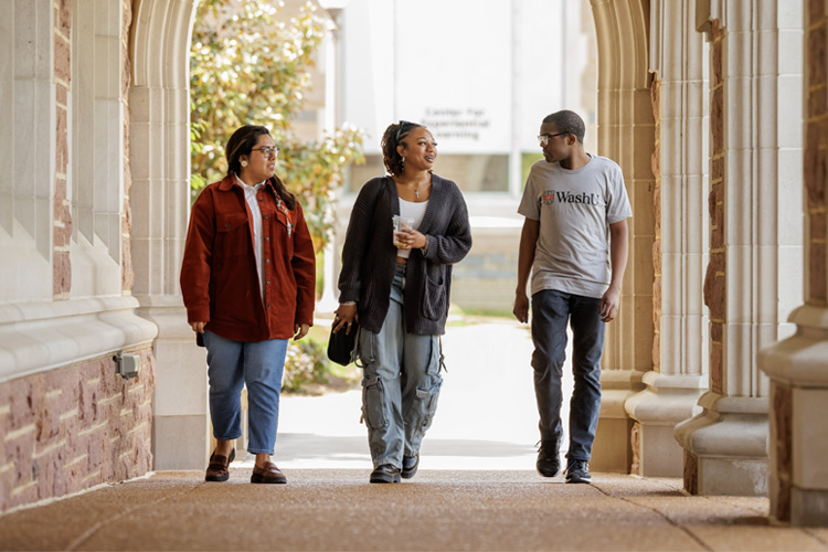 students walking on campus under archway